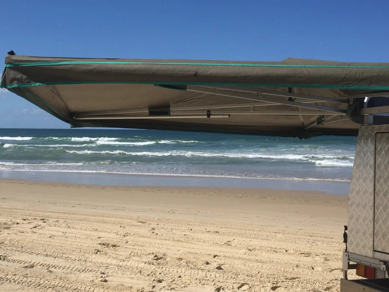 30 Second Wing Awning extending from a vehicle over a beach for shade or shelter