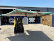 Forklift lifting a 30 Second Wing Awning with extended shade structure for outdoor shelter