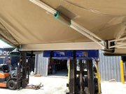 Retractable fabric wing awning attached to building structure for shade and weather protection