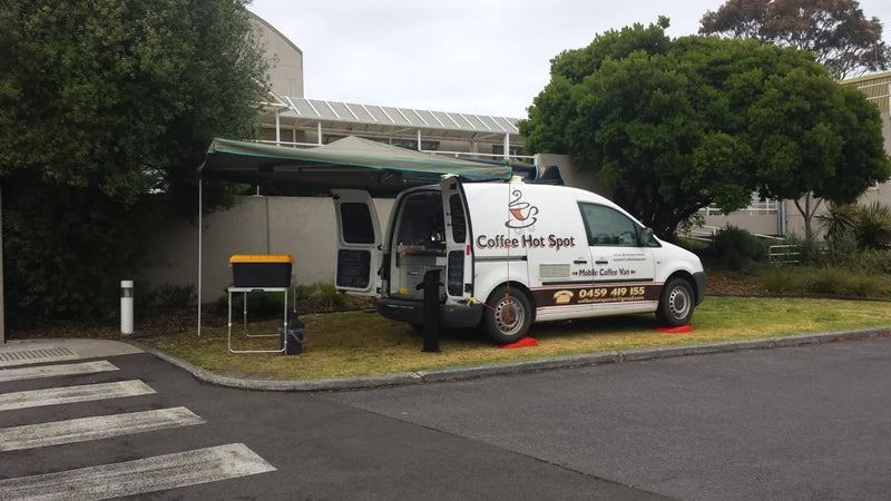 White van with Cardiac Hire Sport branding parked on street showcasing a wing awning