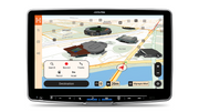 Alpine head unit showing Hema 3D city mode with 3D buildings and a route arrow