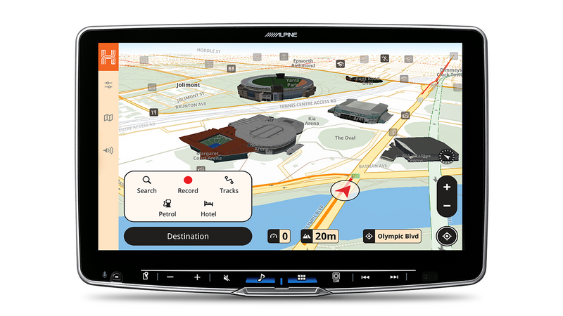 Alpine head unit showing Hema 3D city mode with 3D buildings and a route arrow