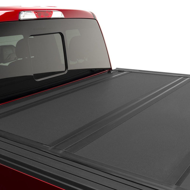 BAKFlip MX4 matte black panels closed behind the cab of a red RAM
