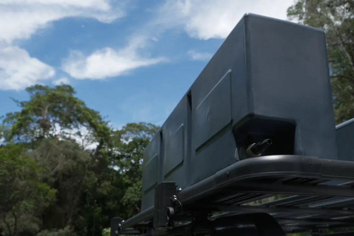 Gray rectangular poly water tank mounted on a vehicle for camper or RV use