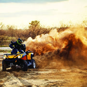 Yellow and black ATV kicking up dust while using Carbon 4500lb ATV Trailer Winch with synthetic rope