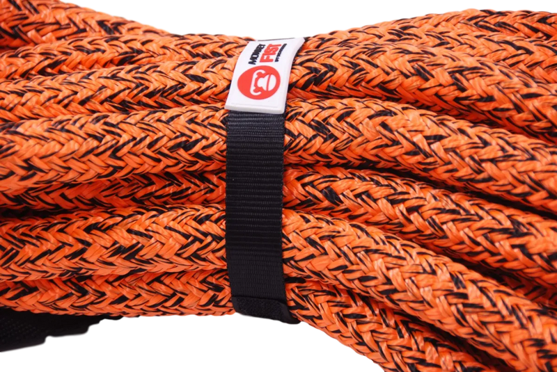 Coiled orange Carbon Offroad kinetic recovery rope secured with a black strap