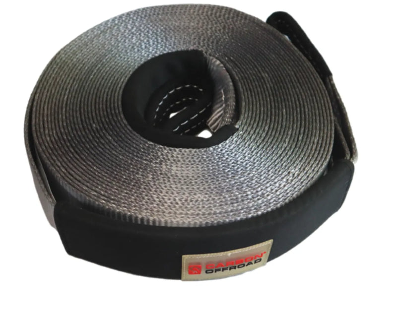 Coiled gray tow strap with black protective sleeve for winch recovery in a recovery kit