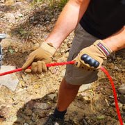Hands wearing work gloves gripping red-handled wire cutters from Carbon Offroad Winch Recovery Kit