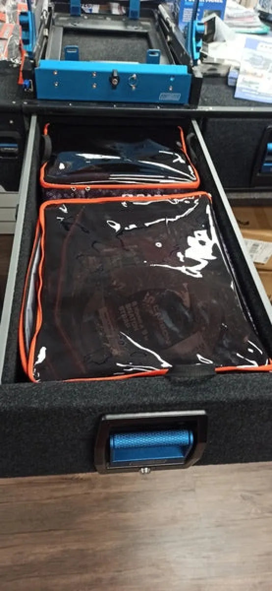 Black foam-lined gear cube storage with compartments for cables in Carbon Offroad gear cube