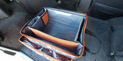 Carbon Offroad gear cube storage with collapsible container and orange trim on car seat