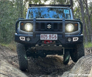 Rugged Suzuki off-road vehicle with Carbon Offroad Mega Pro Winch Hook on dirt trail