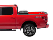 Red pickup truck with 4x4 badge and alloy wheels showcasing Extang Trifecta E-Series soft folding truck bed cover