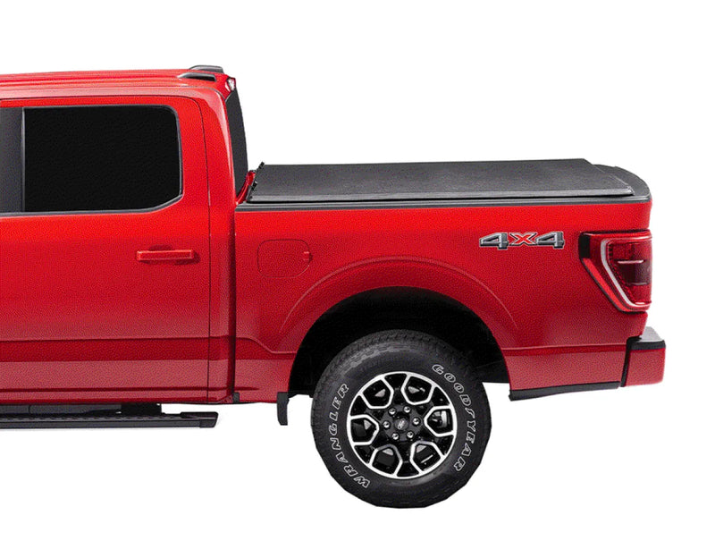 Red pickup truck with covered truck bed and 4x4 badging under the Extang Trifecta E-Series soft folding truck bed cover