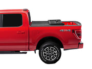 Red pickup truck with covered bed and distinctive wheels featuring Extang Trifecta E-Series soft folding truck bed tonneau cover