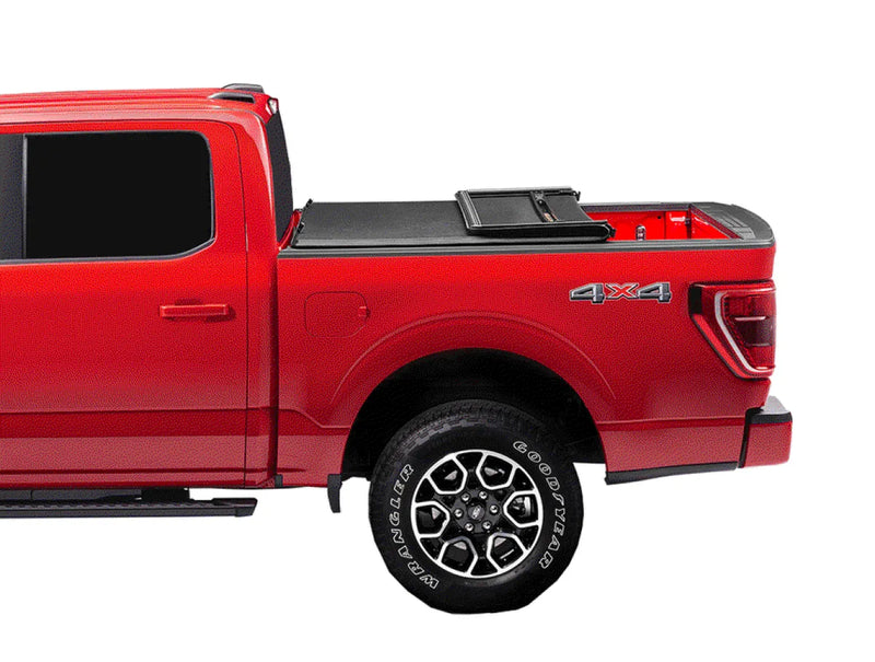 Red pickup truck with covered bed and distinctive wheels featuring Extang Trifecta E-Series soft folding truck bed tonneau cover