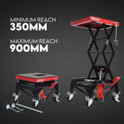 Scissor lift table with minimum and maximum reach measurements on a dark background