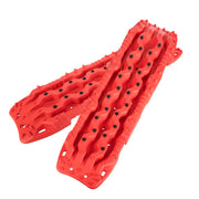 Red plastic recovery boards with textured surface and holes for vehicle traction