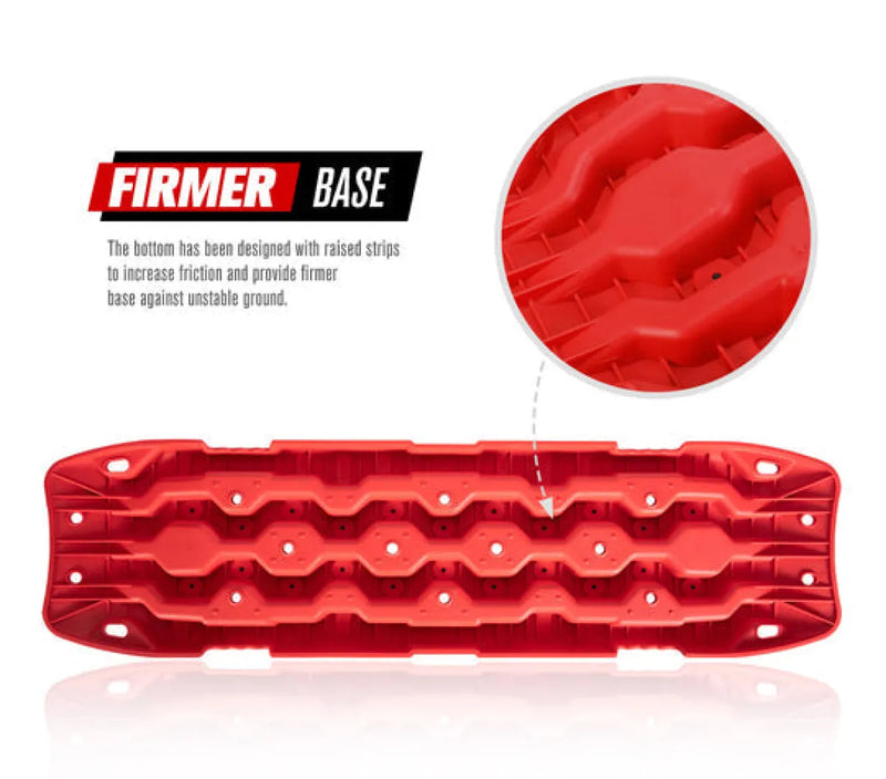 Red plastic recovery boards with wavy ridges and traction holes for off-road recovery tracks