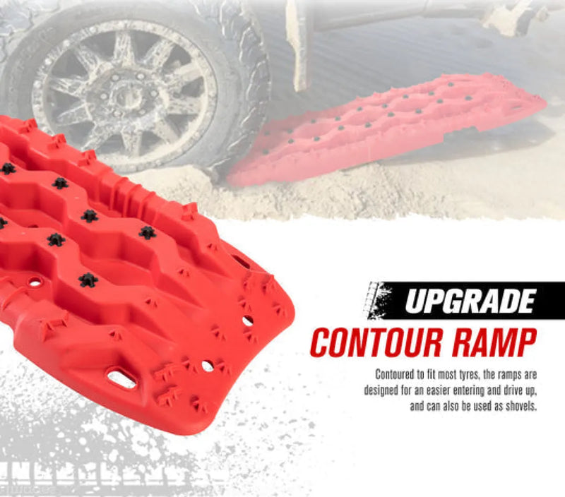 Red plastic recovery boards with textured surface and holes for off-road vehicle traction