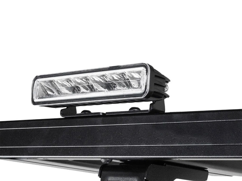 LED light bar mounted on vehicle roof rack with Front Runner bracket