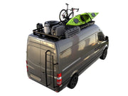 Gray van with roof rack kit carrying outdoor gear including bicycle and kayak