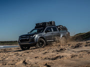 Off-road pickup truck with Front Runner Slimline II roof rack kit on sandy beach