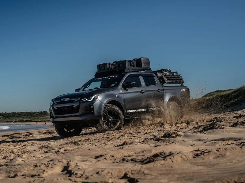 Off-road pickup truck with Front Runner Slimline II roof rack kit on sandy beach