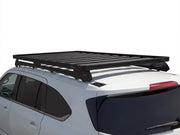 Black roof rack mounted on white SUV showcasing Front Runner Slimline II Roof Rack Kit