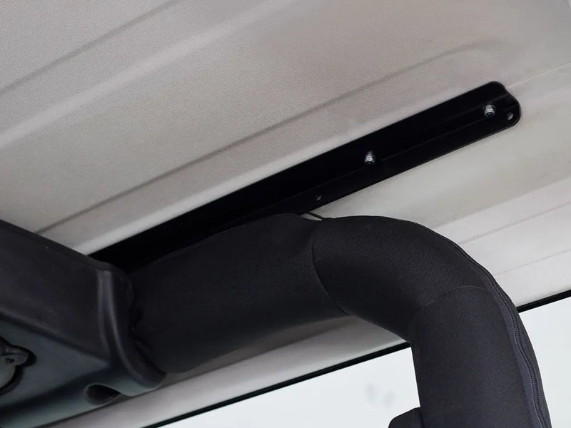Black metal hinge attached to surface for Jeep Wrangler roof rack kit