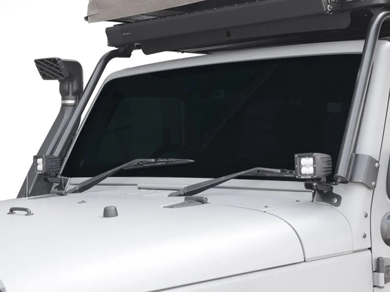 Off-road vehicle snorkel mounted near JKU windshield spot light brackets on a 4x4