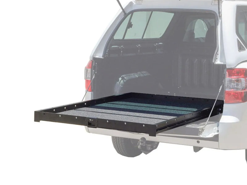 Sliding truck bed cargo slide extending from SUV for organized load bed cargo storage