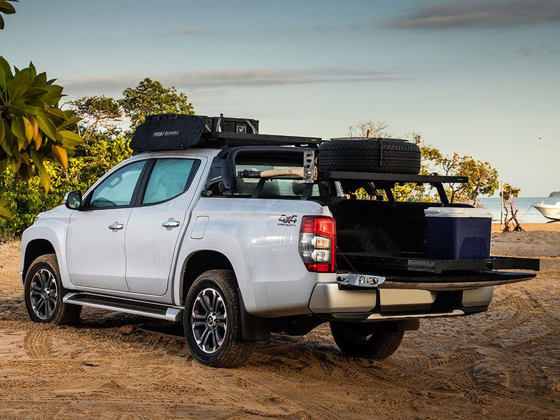 Silver pickup truck with camping gear on Front Runner Load Bed Cargo Slide in load bed