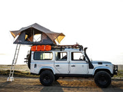 Off-road vehicle with rooftop tent mounted on Front Runner LR Defender 110 Slimline II roof rack kit