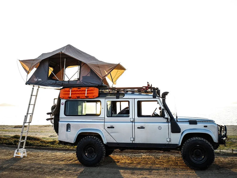 Off-road vehicle with rooftop tent mounted on Front Runner LR Defender 110 Slimline II roof rack kit