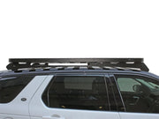 Roof rack kit featuring Slimline II Tray mounted on vehicle for versatile storage