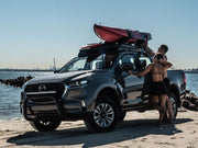 Mazda BT50 pickup truck with kayak on roof rack, showcasing the Front Runner slimline ii roof rack kit