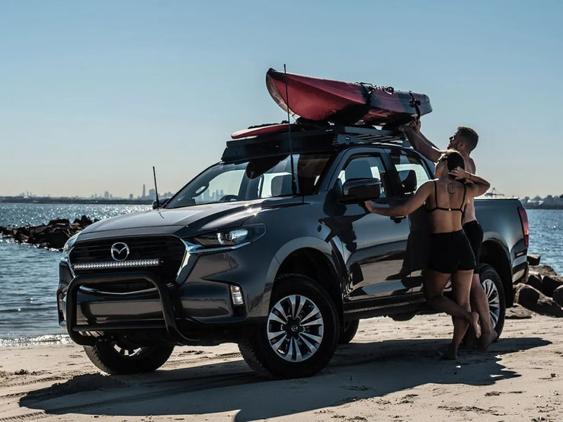 Mazda BT50 pickup truck with kayak on roof rack, showcasing the Front Runner slimline ii roof rack kit