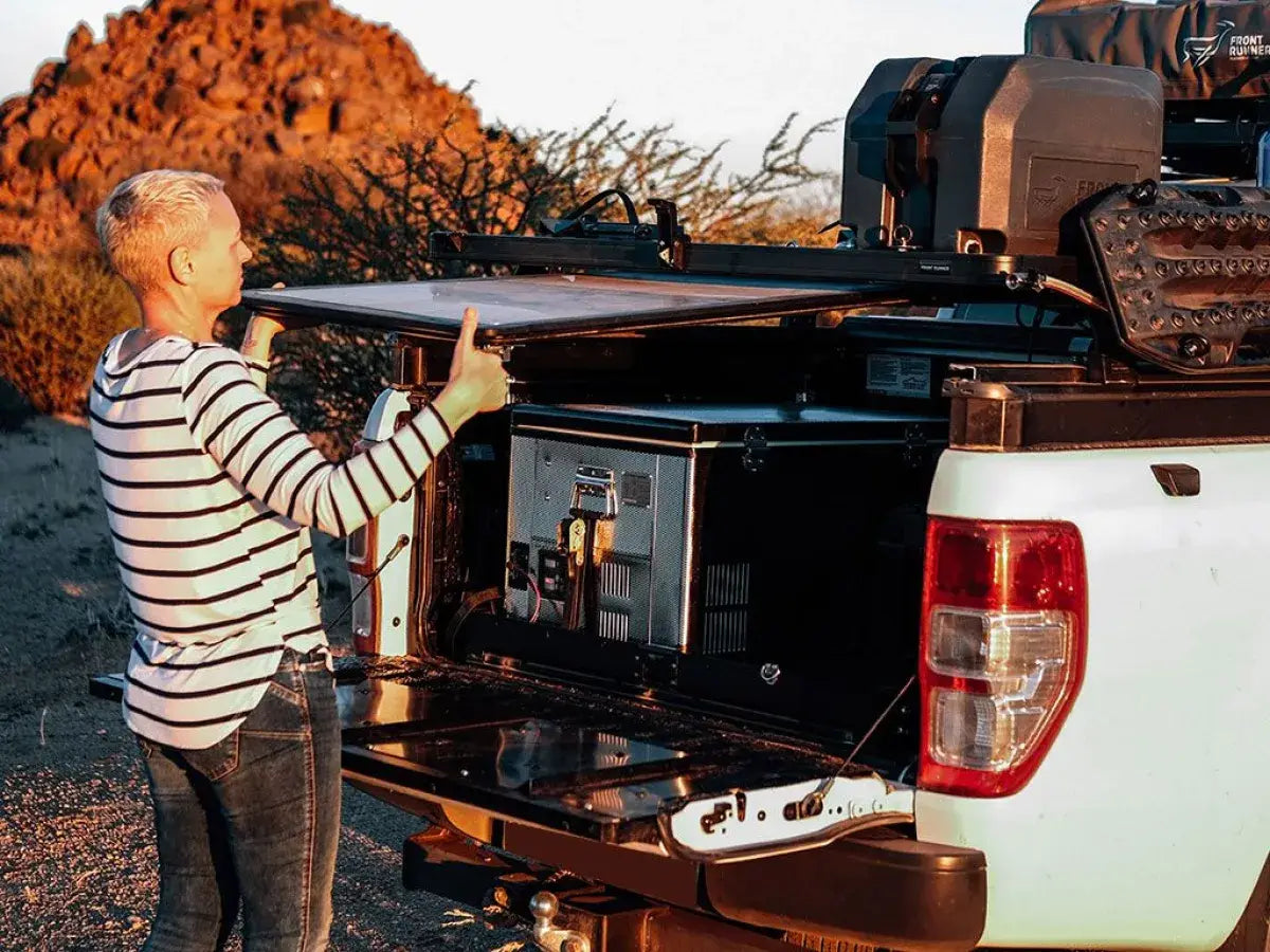 Removing the camp table from beneath a rack on a ute
