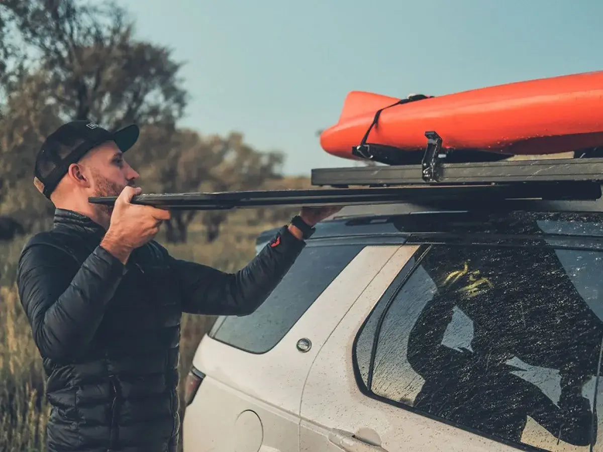 Sliding the camp table out from under a vehicle roof rack