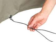 Hand adjusting a bungee cord on a light-colored fabric surface in Front Runner Rack Mount Shower Cubicle