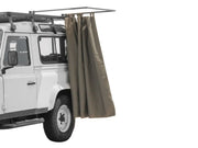 Vehicle-mounted awning on rugged off-road vehicle with Front Runner Rack Mount Shower Cubicle