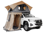 Rooftop tent annex on white Toyota pickup truck for spacious outdoor camping experience