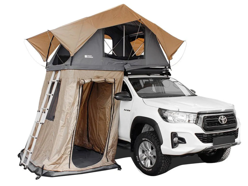 Rooftop tent annex on white Toyota pickup truck for spacious outdoor camping experience