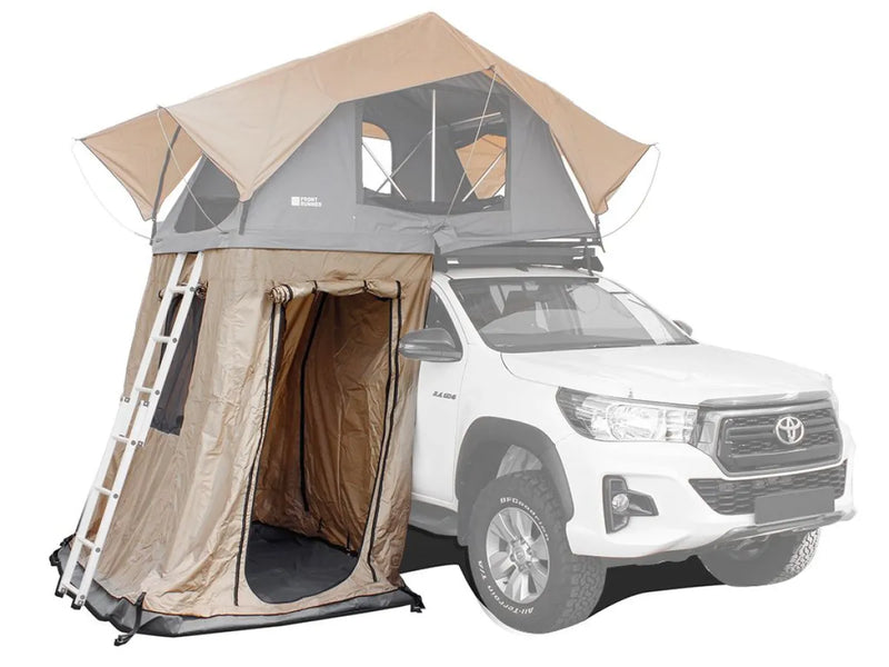 Rooftop tent annex mounted on white Toyota pickup truck for a spacious runner roof setup