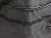 Zipper on a dark fabric transit storage bag with Velcro strip for large roof cargo