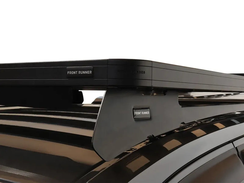 Roof rack mounted on a vehicle featuring the Front Runner Slimline II Tray Roof Rack Kit for Nissan Navara D23