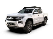 White Volkswagen pickup truck with Front Runner Slimline II Roof Rack Kit and off-road tires
