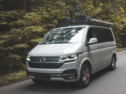 Silver Volkswagen van with bicycle on Slimline II roof rack tray for T6 Caravelle