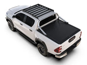 White Toyota Hilux pickup truck with roof rack and bed cover showcasing Front Runner Slimsport Roof Rack Kit