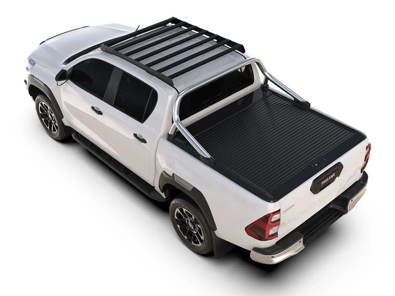 White Toyota Hilux pickup truck with roof rack and bed cover showcasing Front Runner Slimsport Roof Rack Kit